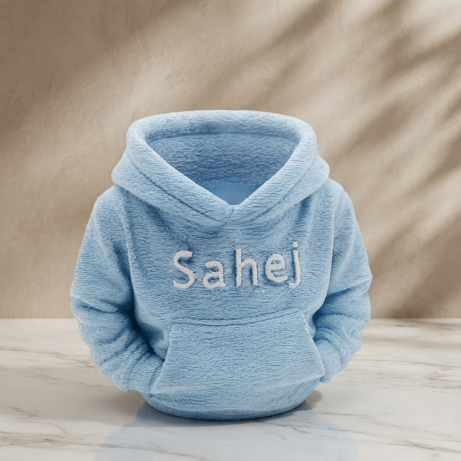 3D printed personalised hoodie organiser in light Blue with name Sahej hand-painted in white