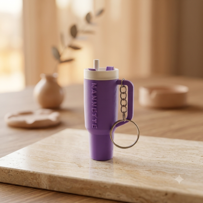 Sipper shaped keychain in purple colour with name Nannette
