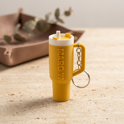 Sipper shaped keychain in yellow colour with name Marg W